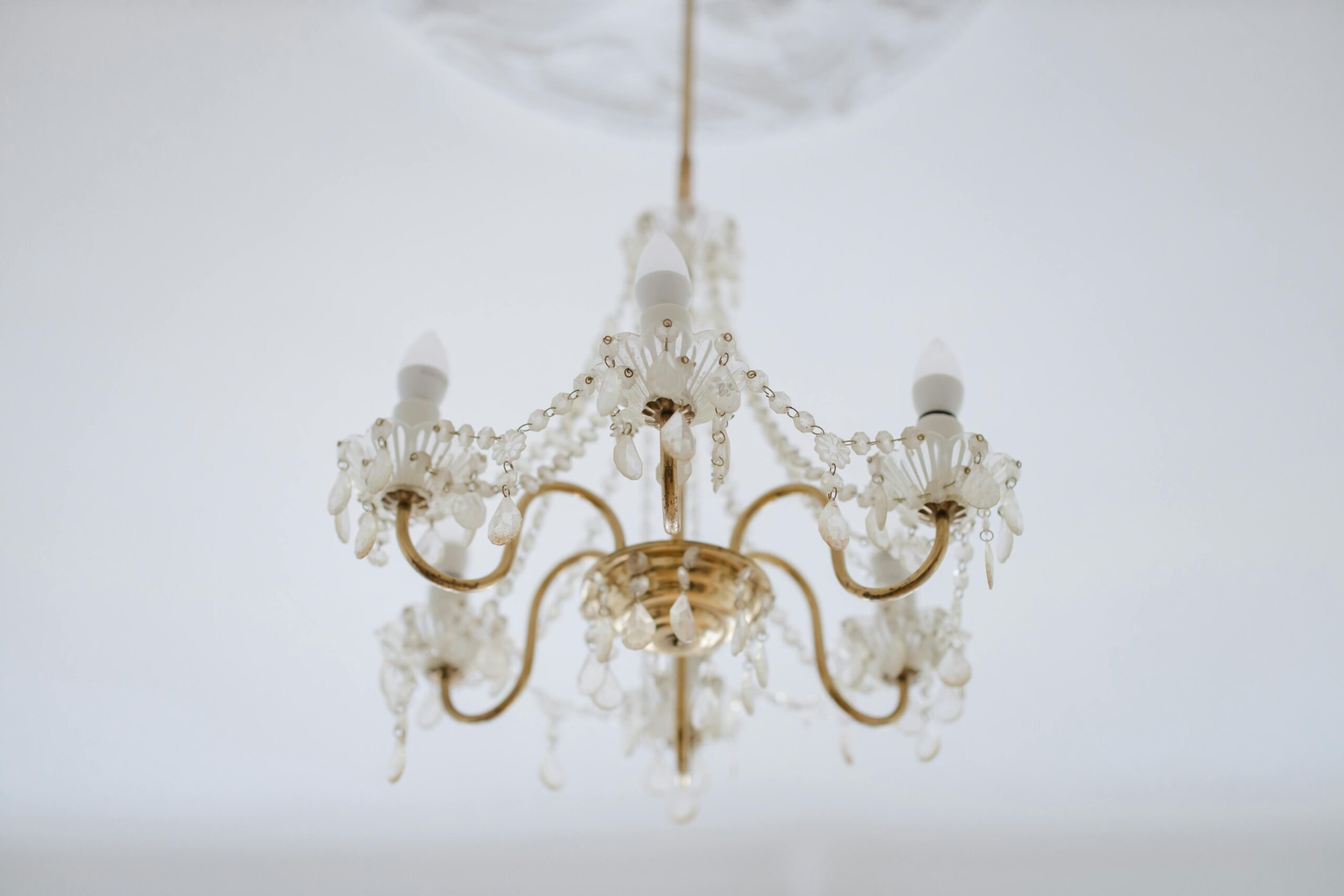 Classic crystal chandelier with intricate details hanging indoors, showcasing elegance and sophisticated decor.